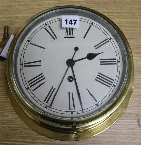 An early 20th century brass bulkhead timepiece, 26cm